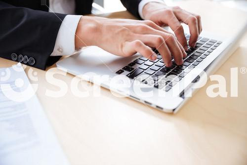 Closeup Of Hands Of Professional Using Laptop At The Table